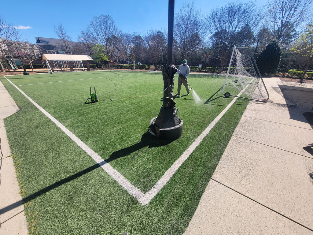 Professional synthetic turf cleaning on a soccer field in North Carolina